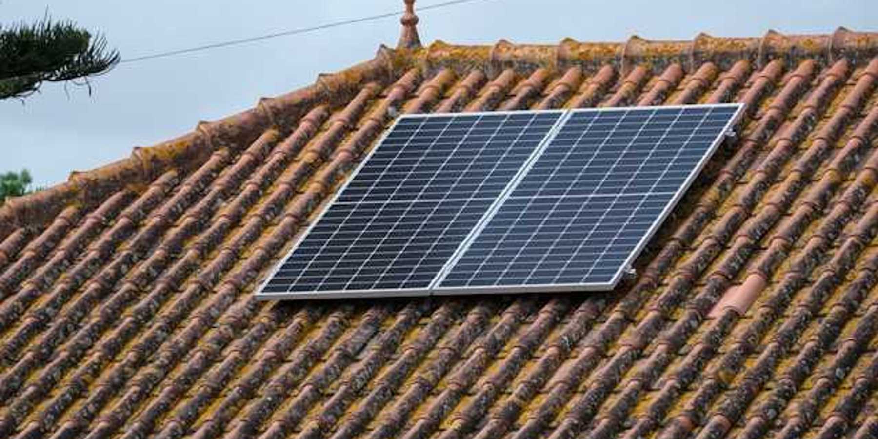 A small rooftop solar panel on a tiled roof