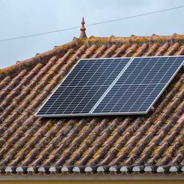 A small rooftop solar panel on a tiled roof