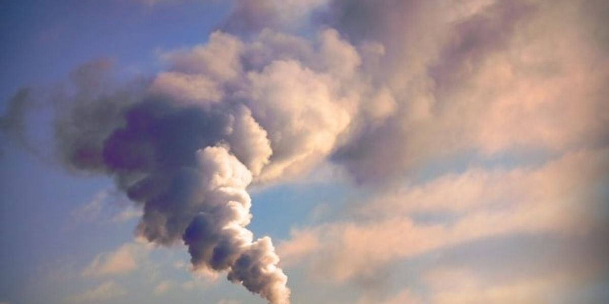 A smokestack with a plume of pollution.