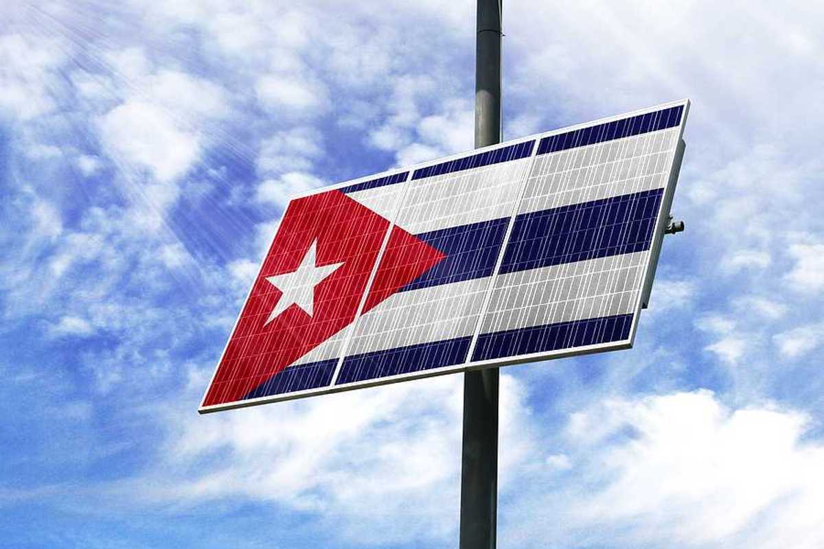A solar panel installed on a pole imprinted with the Cuban flag