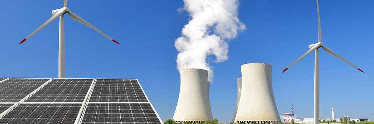 A solar panel with wind turbines and an energy plant in the background