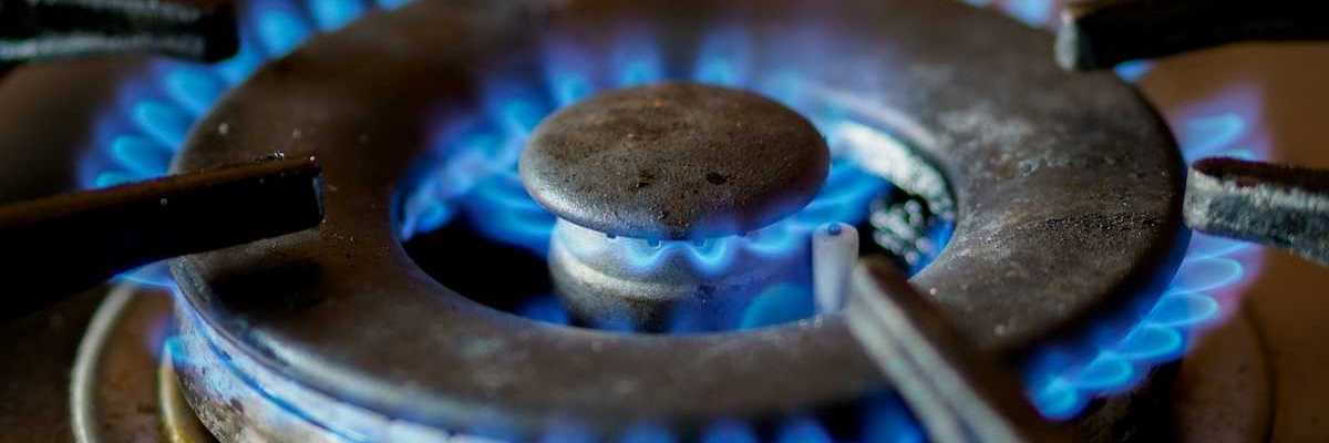 A somewhat-used lit burner on a gas stove
