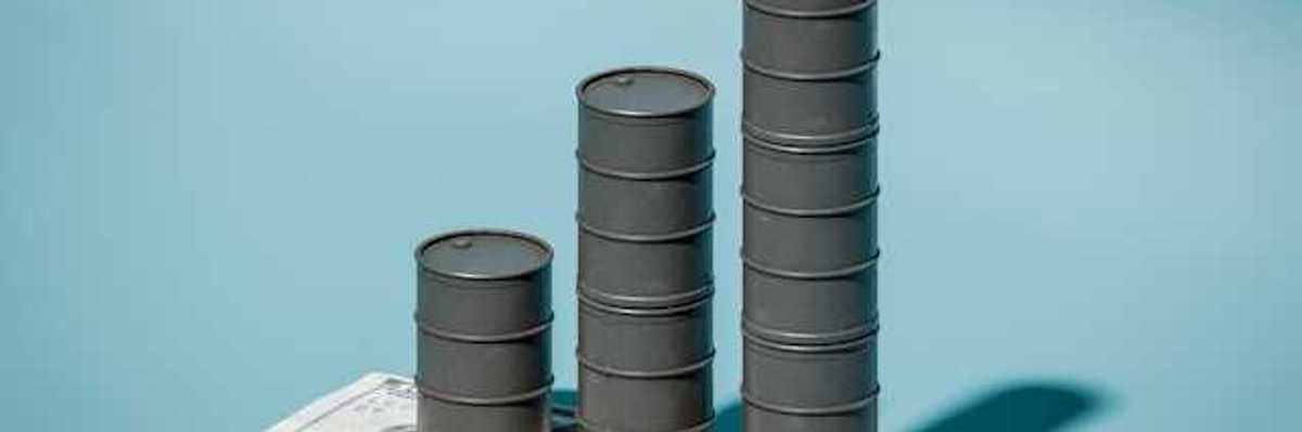 A stack of three oil barrels on top of a one hundred dollar bill against a blue background