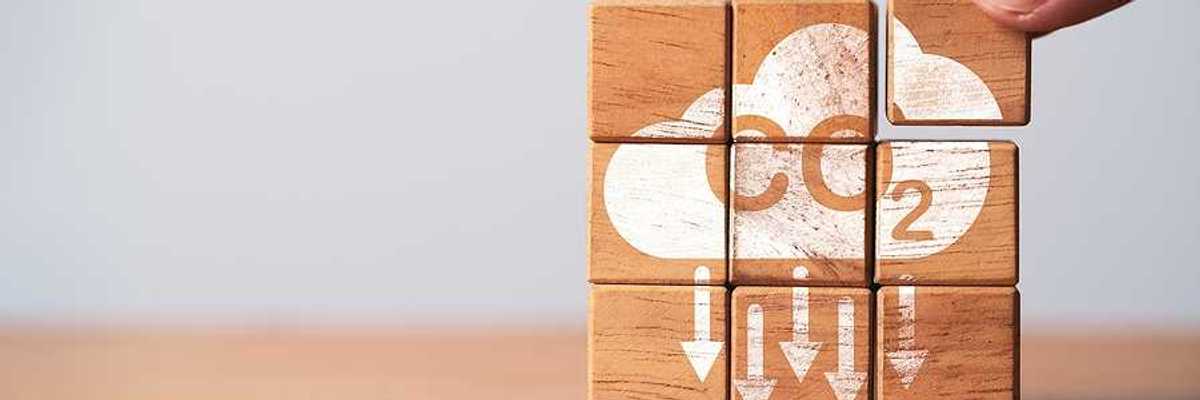 A stack of wooden blocks that say CO2 with arrows pointing downward
