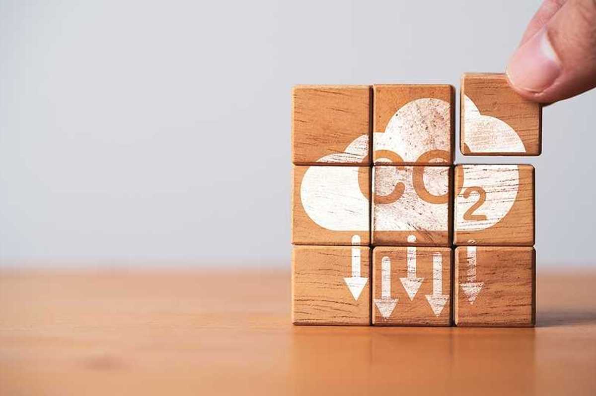 A stack of wooden blocks that say CO2 with arrows pointing downward