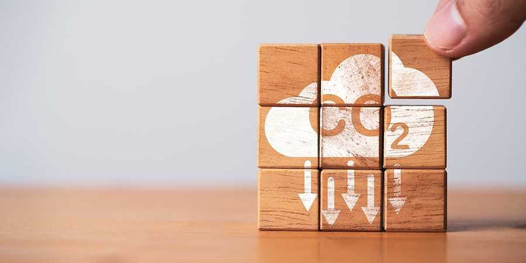 A stack of wooden blocks that say CO2 with arrows pointing downward