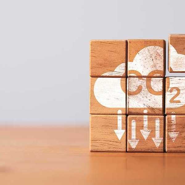 A stack of wooden blocks that say CO2 with arrows pointing downward