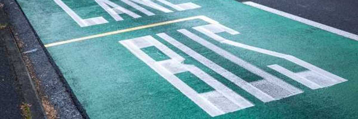 A street with the words Bus Lane painted in one lane