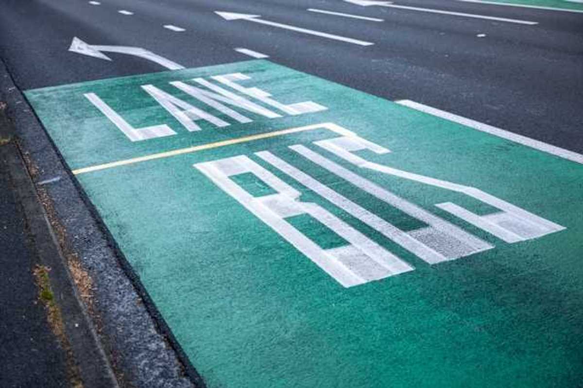 A street with the words Bus Lane painted in one lane