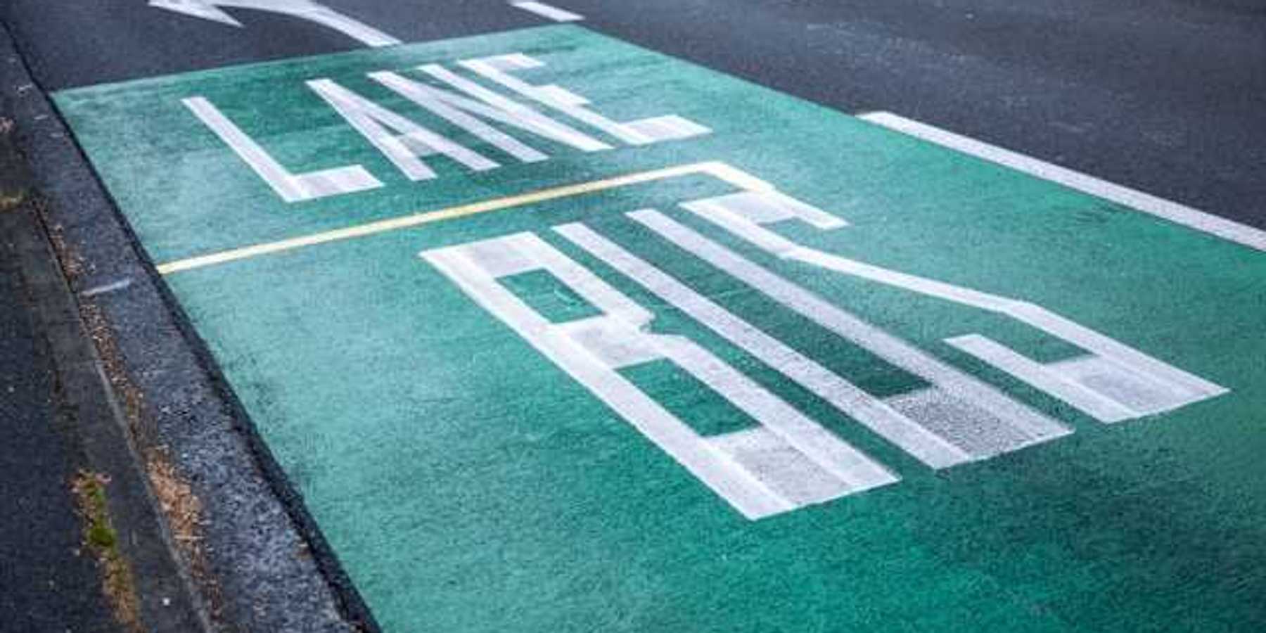 A street with the words Bus Lane painted in one lane