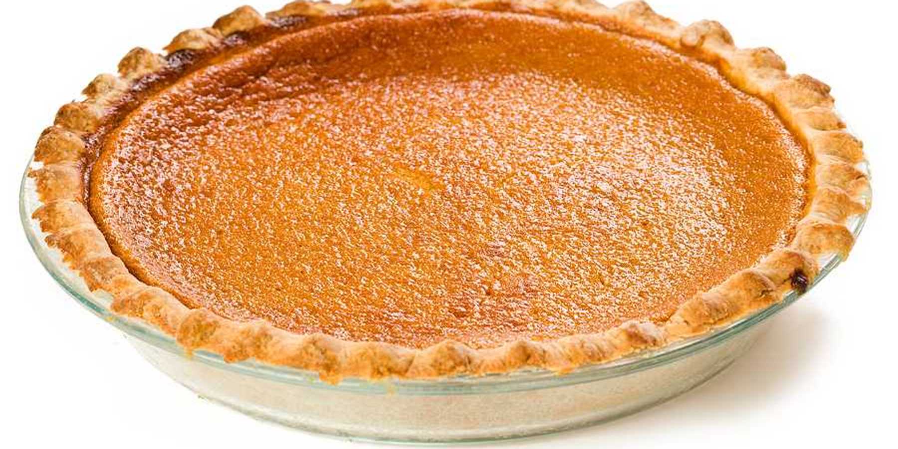 A sweet potato pie sitting on a white surface