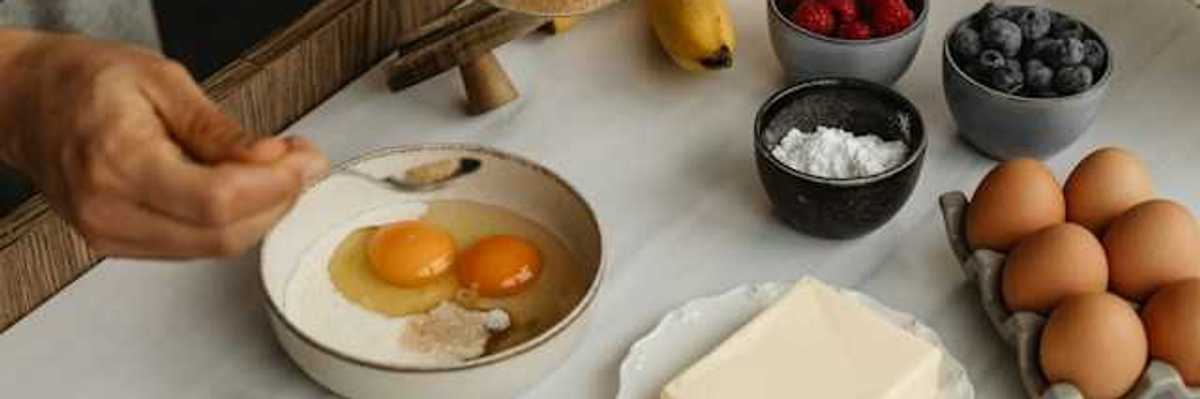 A table with types of food including eggs, butter and fruit