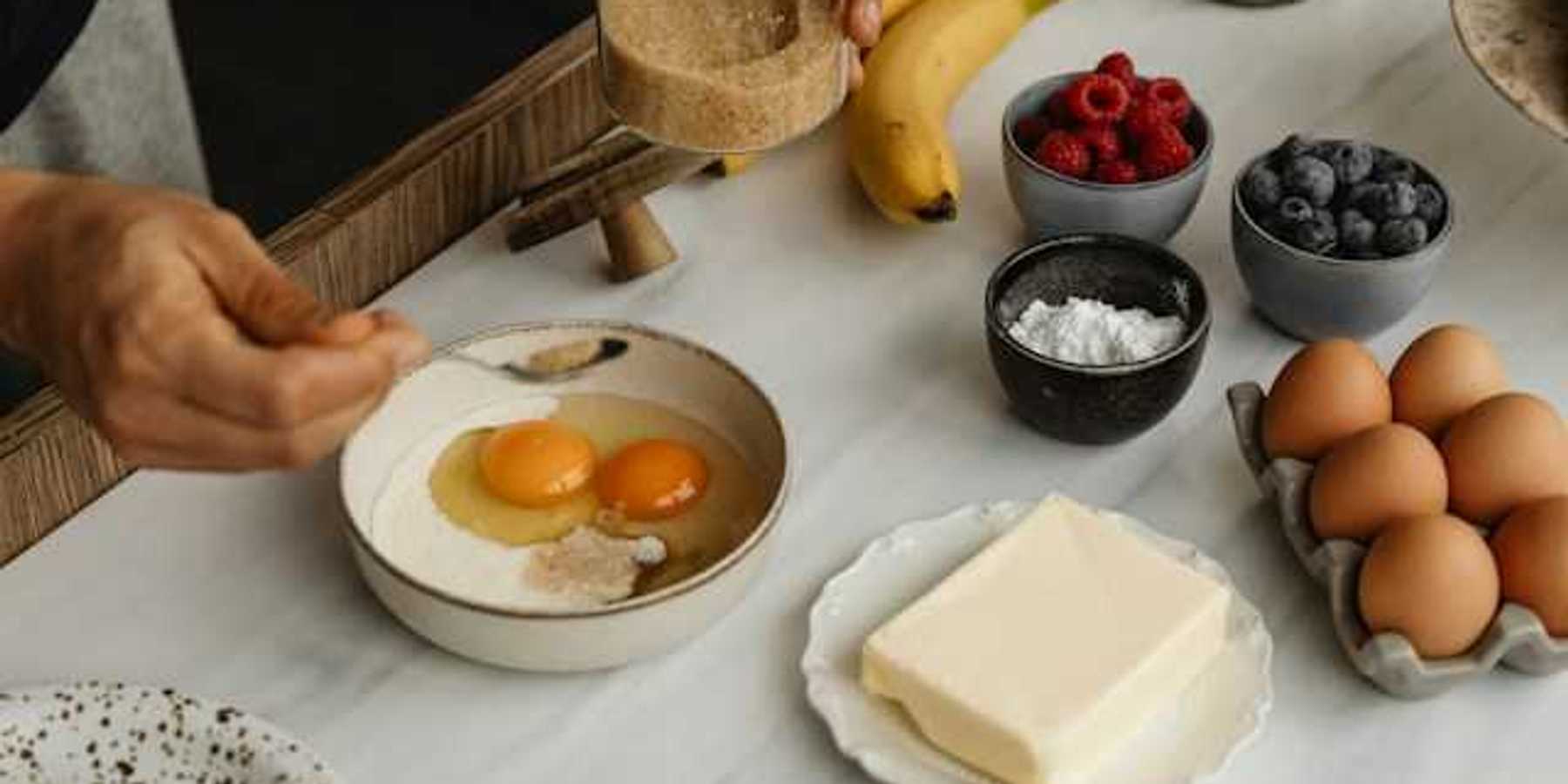 A table with types of food including eggs, butter and fruit