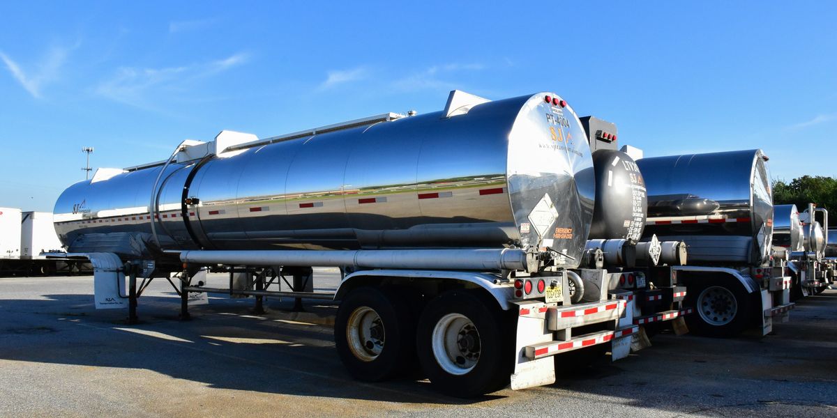 A tanker truck parked in a lot.