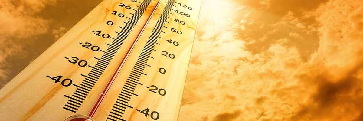 A thermometer pointing skyward towards a searing sun