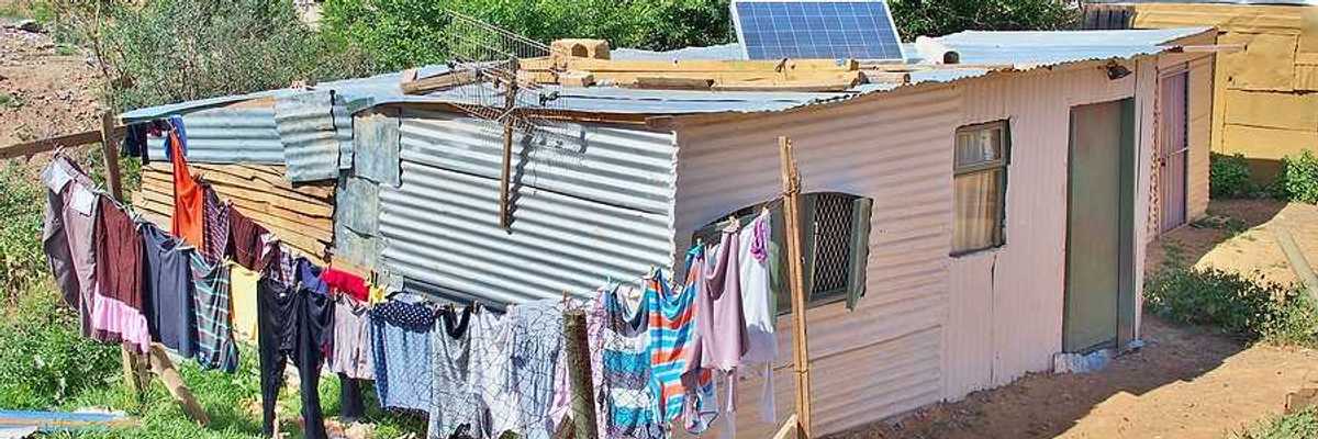A tin hut with a small solar panel on the roof