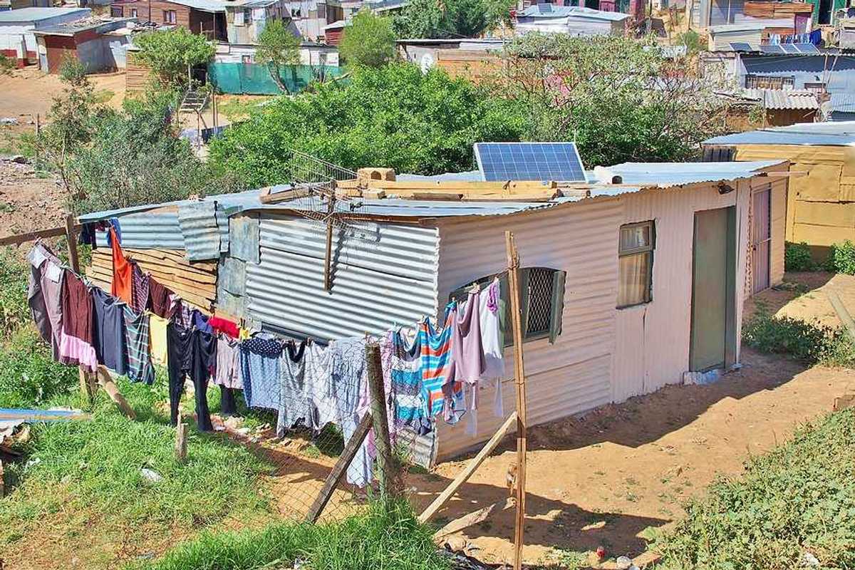 A tin hut with a small solar panel on the roof