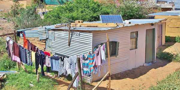 A tin hut with a small solar panel on the roof