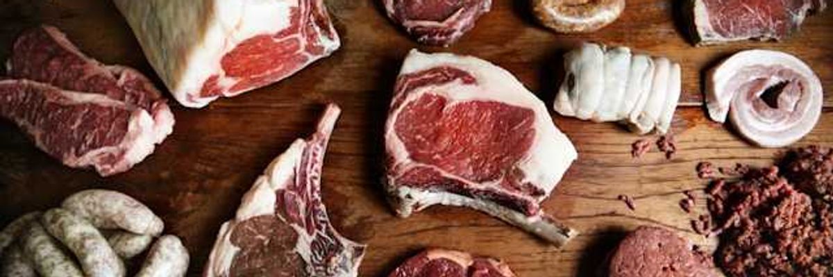 A variety of meat arranged on a wooden surface