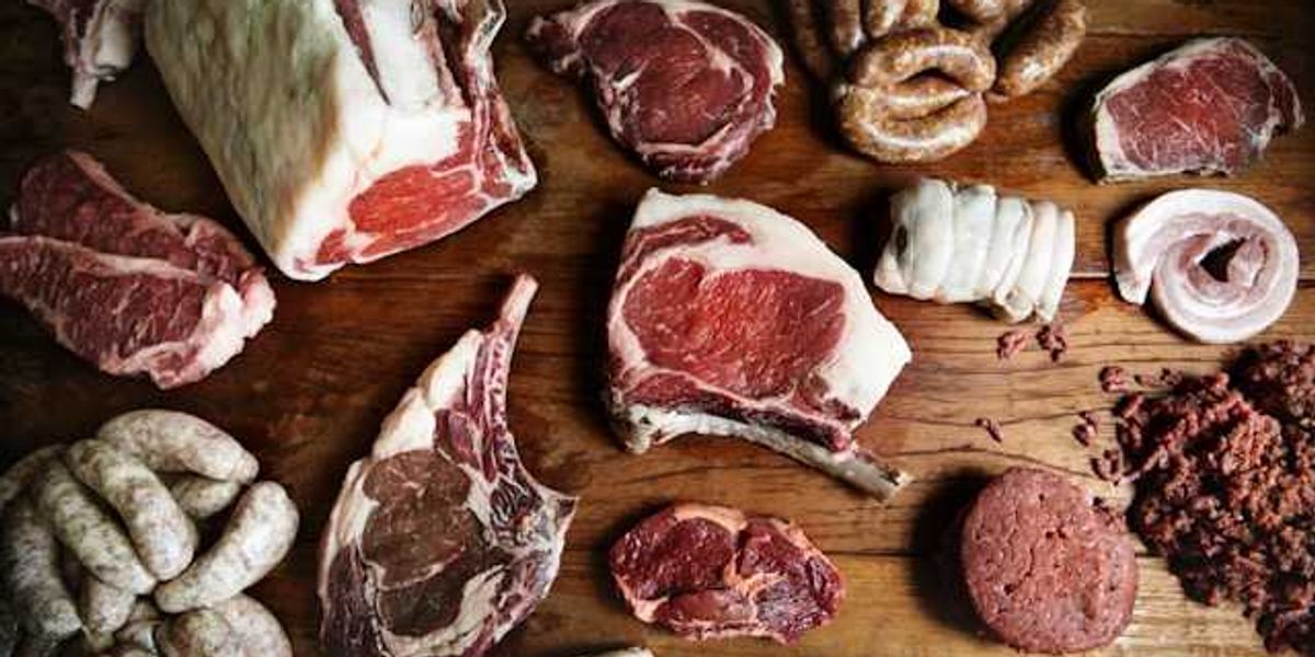 A variety of meat arranged on a wooden surface