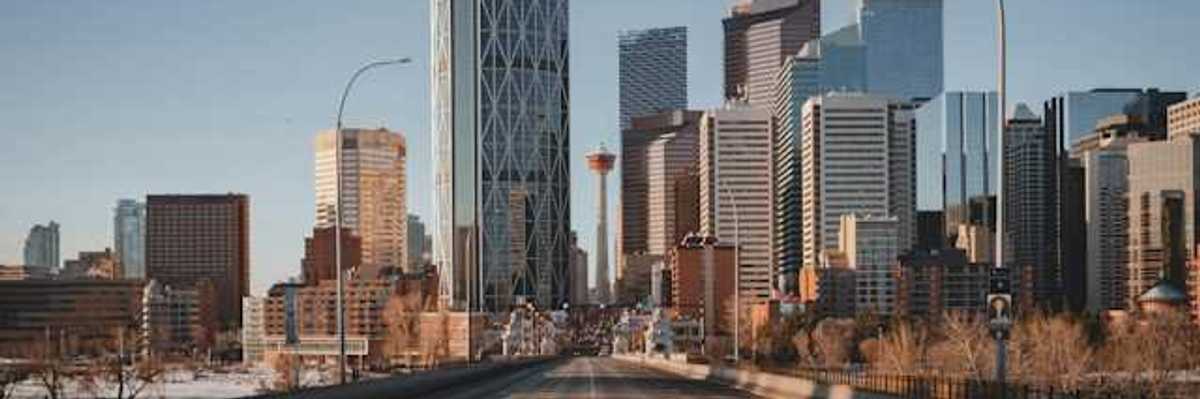 A view down a highway at the skyline of Toronto Canada
