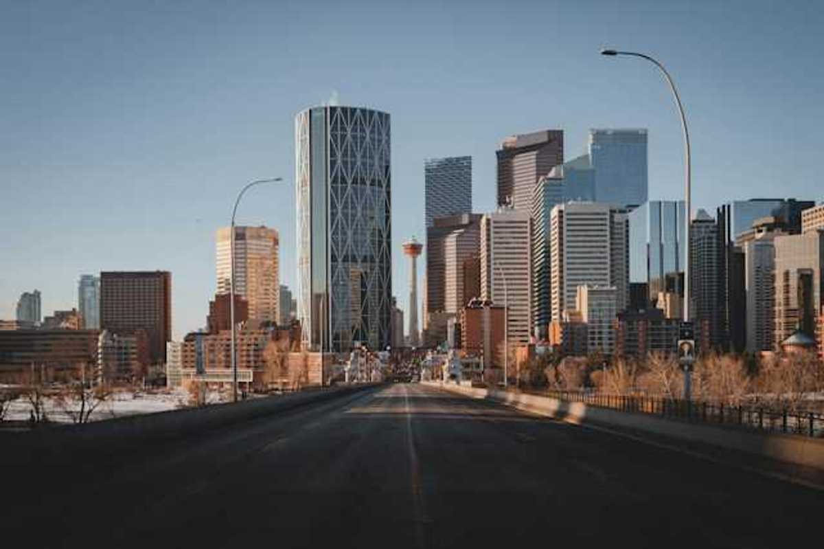 A view down a highway at the skyline of Toronto Canada