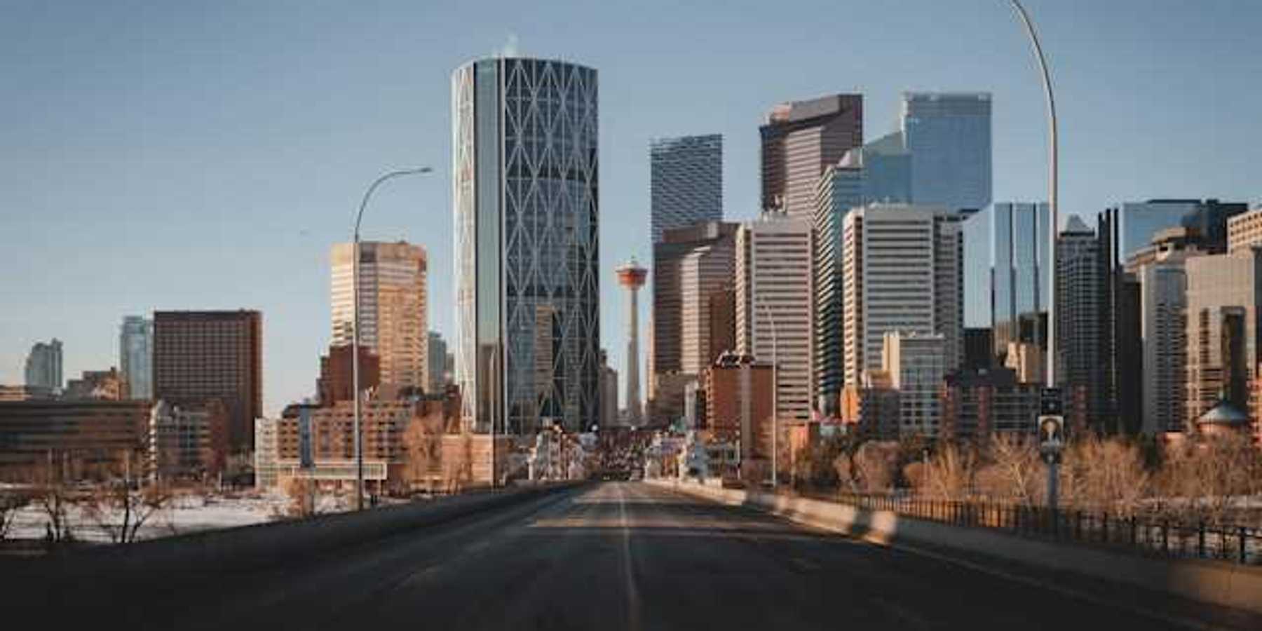 A view down a highway at the skyline of Toronto Canada