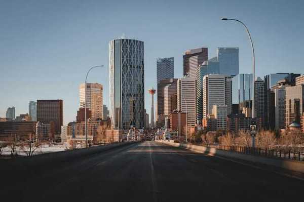 A view down a highway at the skyline of Toronto Canada