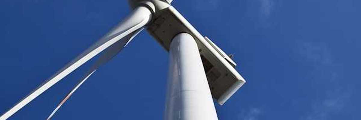 A view from below looking up at a wind turbine