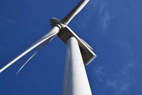 A view from below looking up at a wind turbine