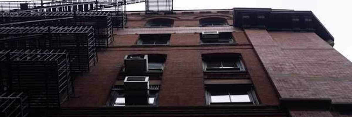 A view from below of a brick apartment building