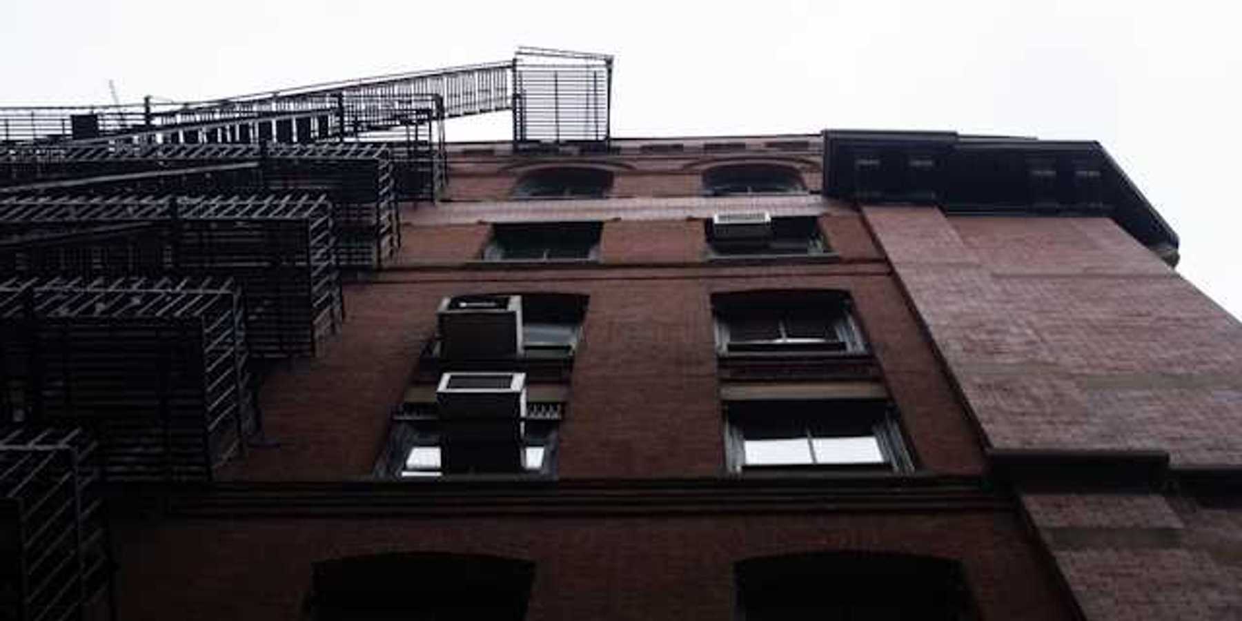 A view from below of a brick apartment building