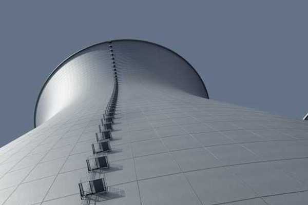 A view from below of a power cooling tower against a blue sky