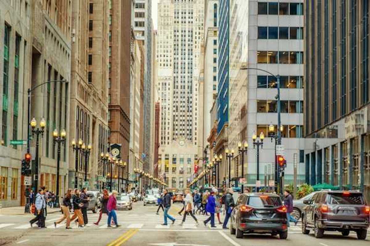 A view of a city street with cars and tall buildings