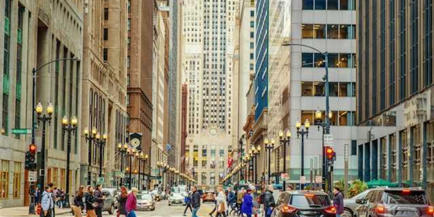A view of a city street with cars and tall buildings