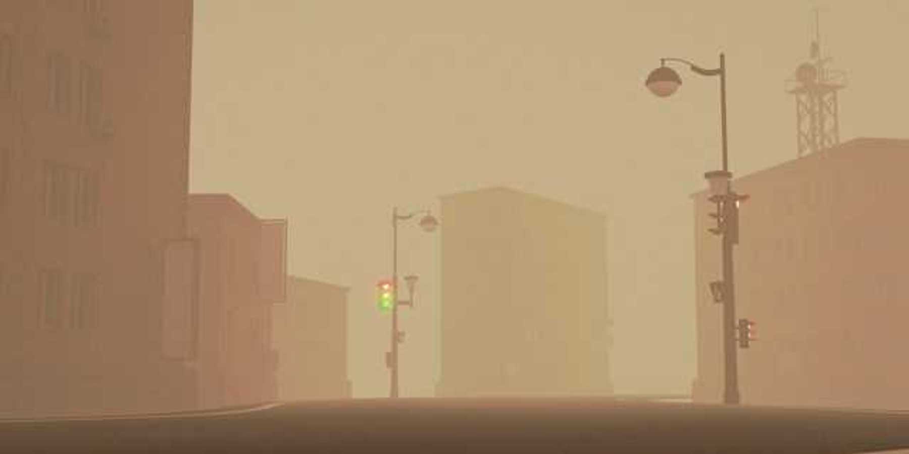 A view of a city street with smog or smoke in the air