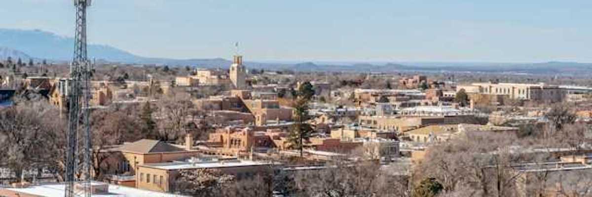 A view of a city with a cell tower in the foreground