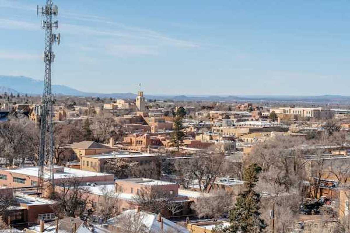 A view of a city with a cell tower in the foreground