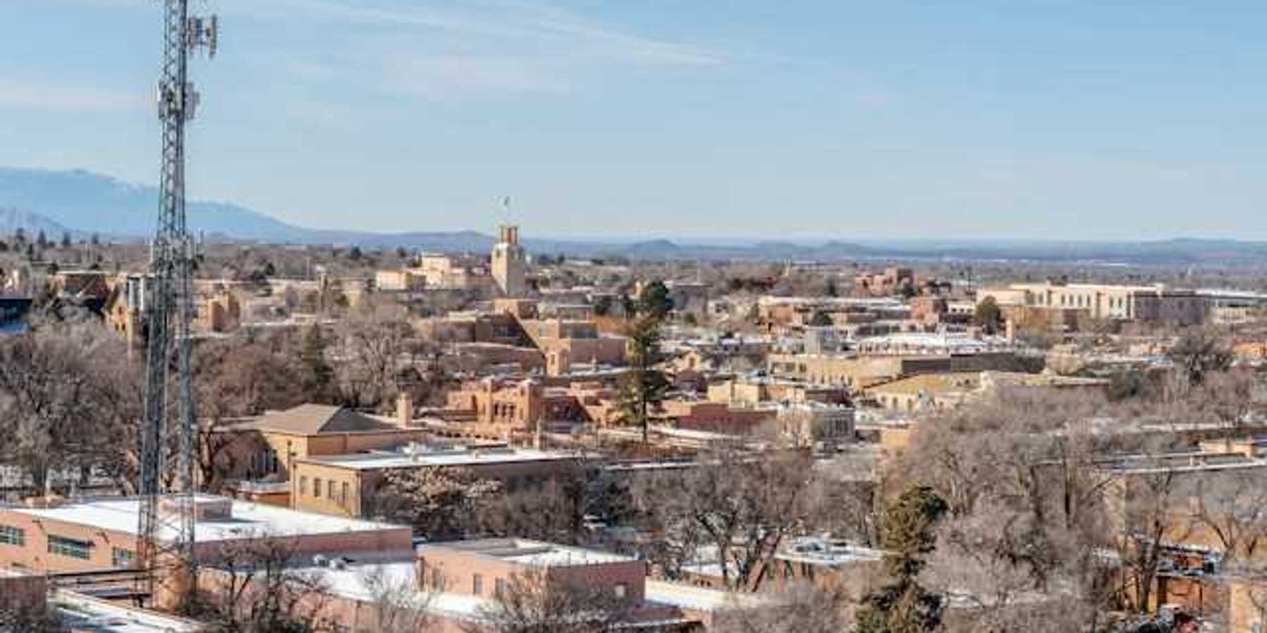 A view of a city with a cell tower in the foreground
