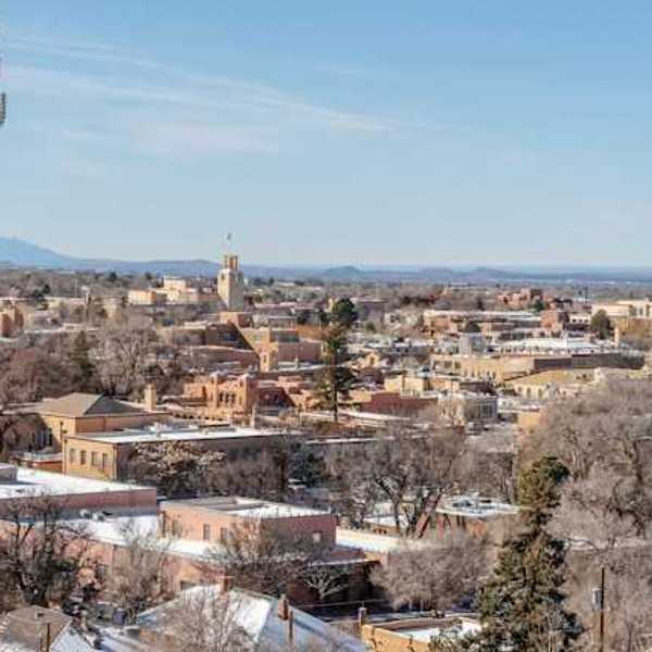 A view of a city with a cell tower in the foreground