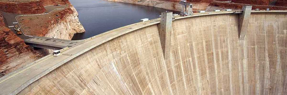 A view of a dam with a reservoir in the background