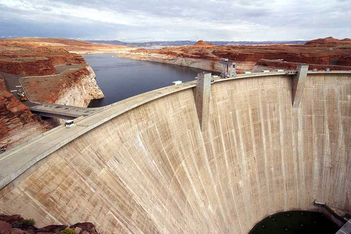 A view of a dam with a reservoir in the background