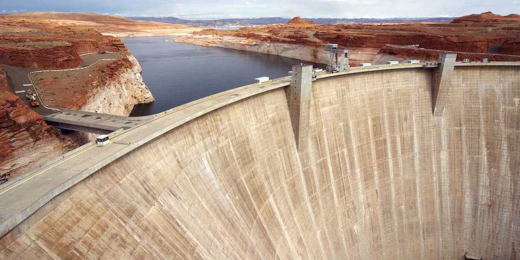 A view of a dam with a reservoir in the background
