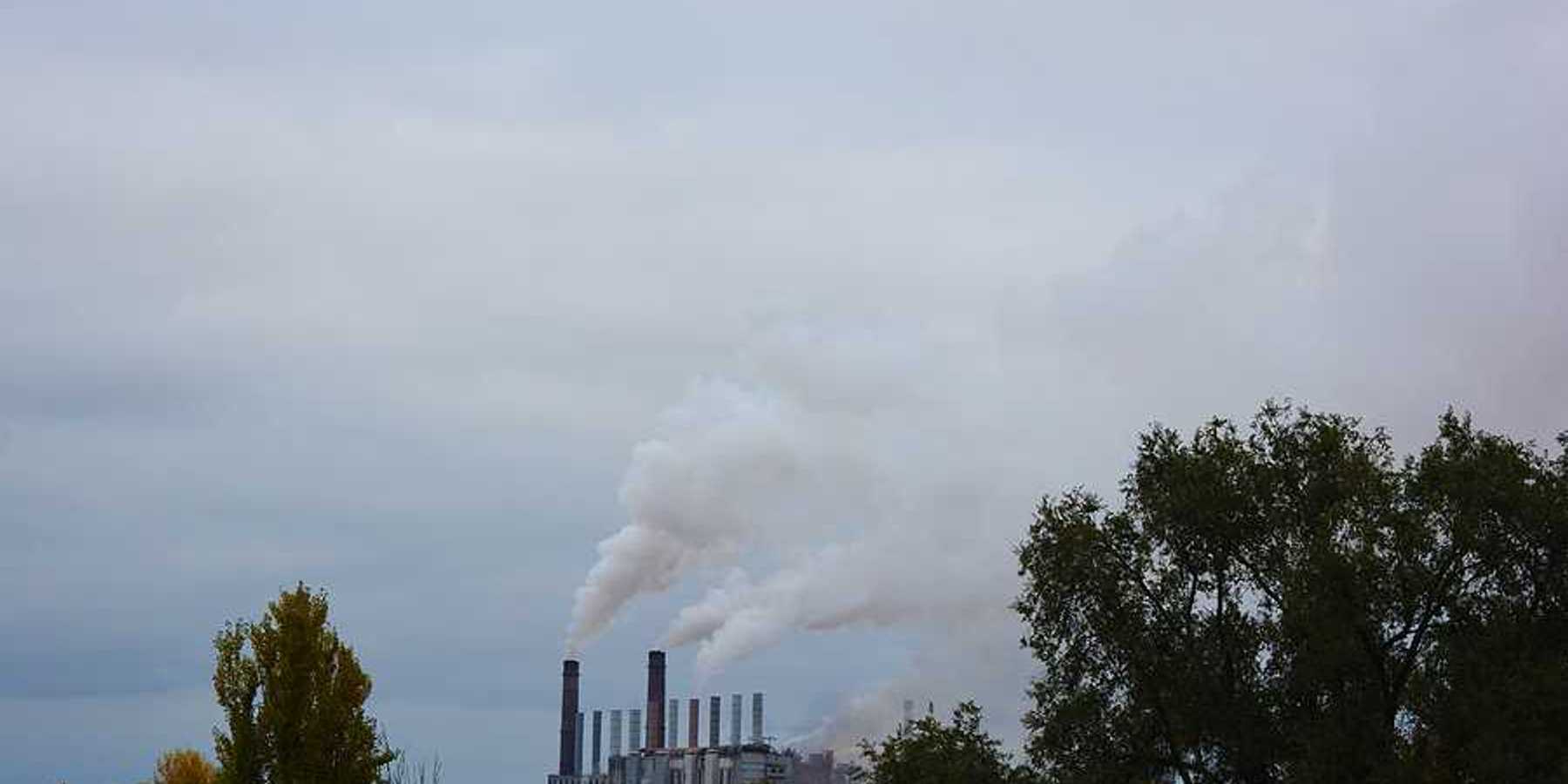 A view of a factory with smoke spewing into the air