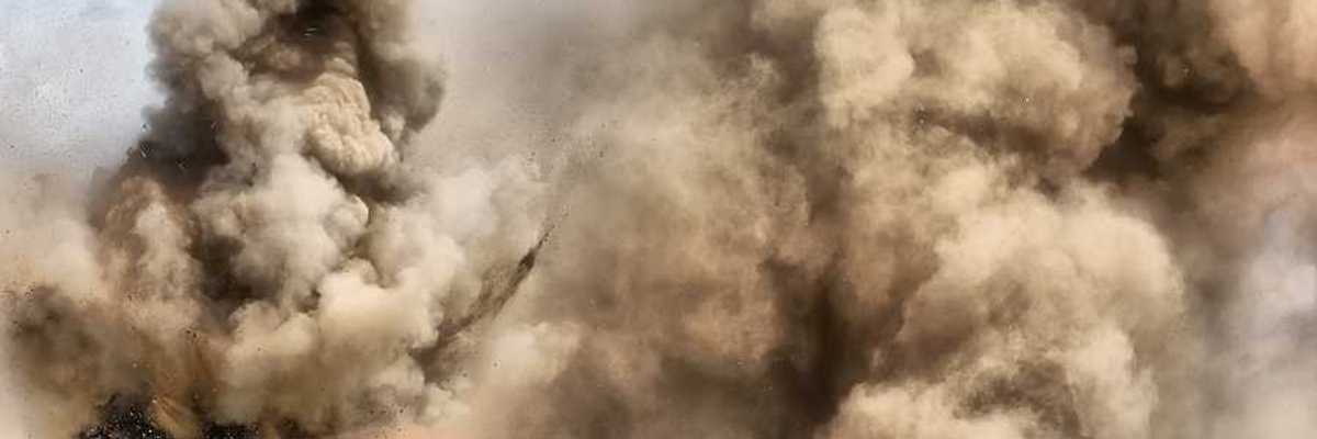 A view of a field under attack with bombs exploding