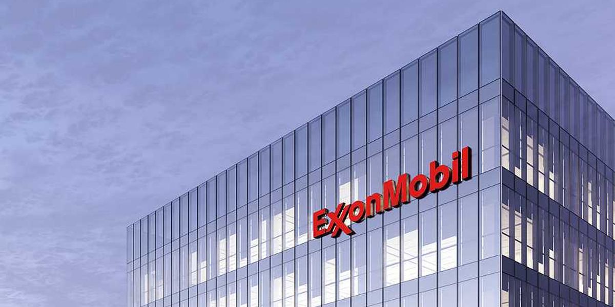 A view of a glass office building with the words ExxonMobil on the side