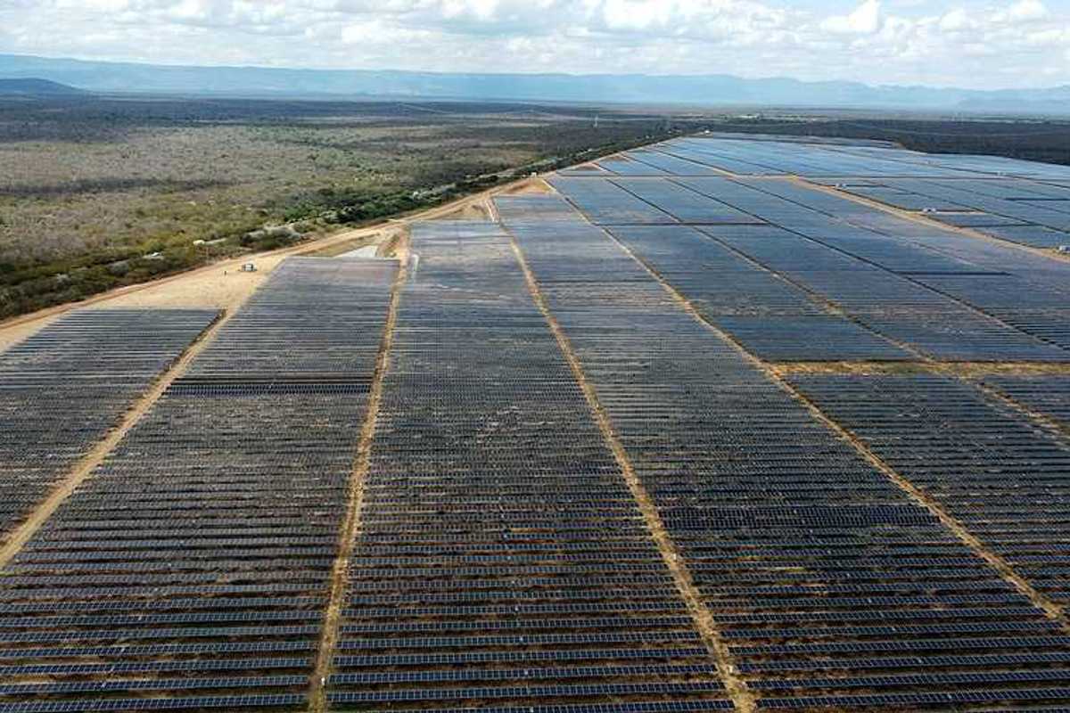 A view of a huge solar farm in Brazil with mountain ranges in the background