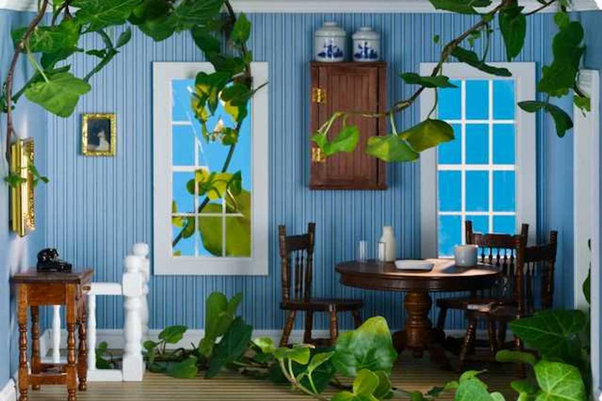A view of a miniature living room with doll-sized furniture