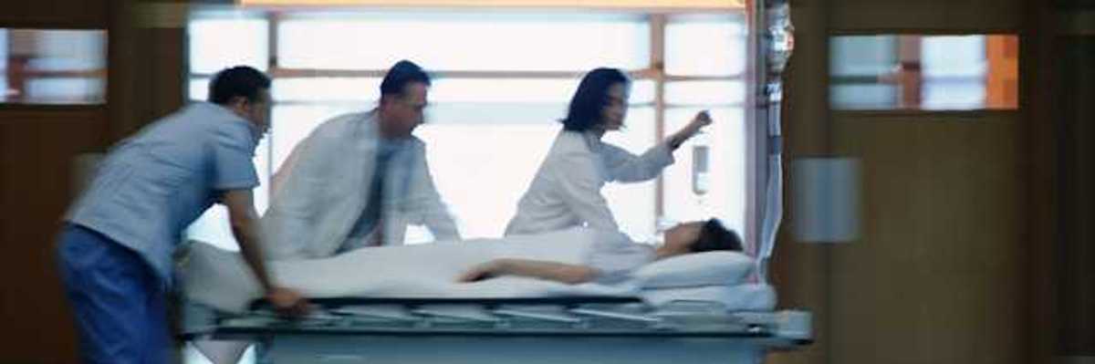 A view of a patient on a gurney being rushed through a hospital