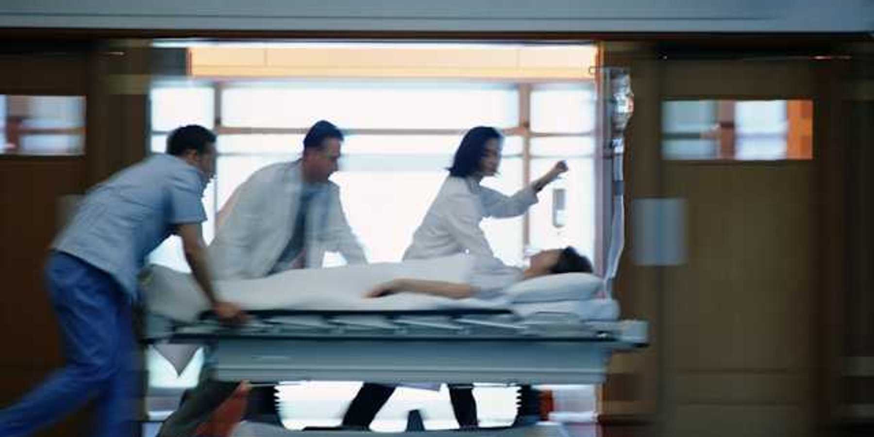 A view of a patient on a gurney being rushed through a hospital